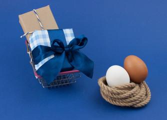 two Easter eggs on blue paper background