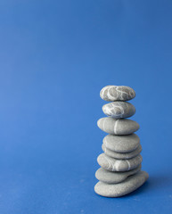 Fototapeta na wymiar Stack of stones on wooden table, space for text. Zen concept