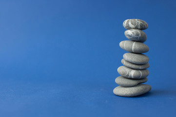 Stack of stones on wooden table, space for text. Zen concept