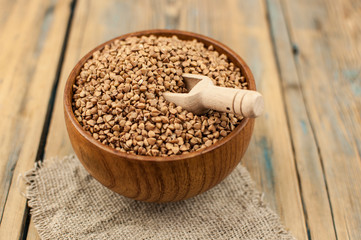 Buckwheat in bowl on table, spoons, top view