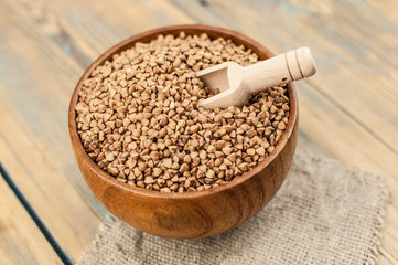 Buckwheat in bowl on table, spoons, top view
