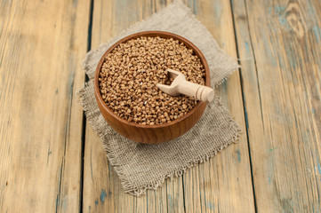 Buckwheat in bowl on table, spoons, top view