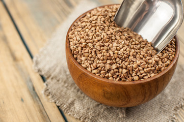 Buckwheat in bowl on table, spoons, top view