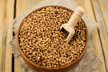 Buckwheat in bowl on table, spoons, top view
