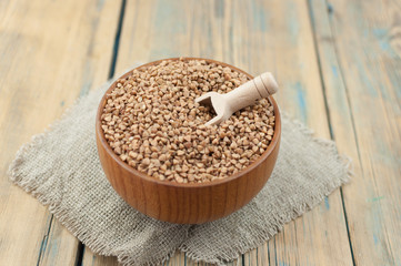 Buckwheat in bowl on table, spoons, top view