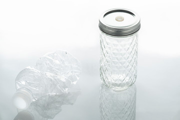 A plastic bottle and a glass bottle