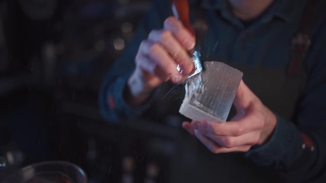 slow motion of bartender crashing ice cube for alcoholic cocktail