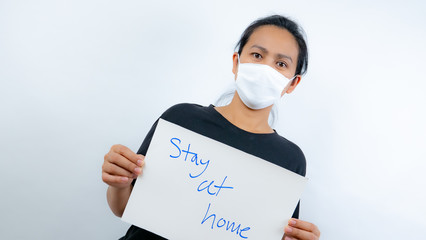 A woman with a sign stay at home in covid-19 spread