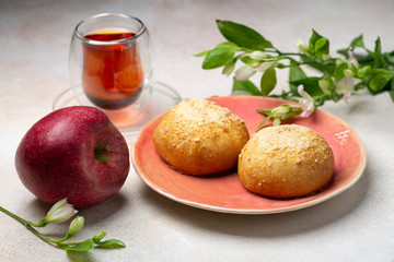Sweet patties with apple and cup of tea 