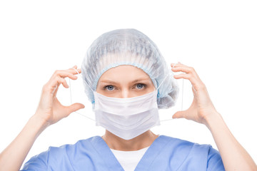 Contemporary young doctor, dentist or surgeon putting on protective mask