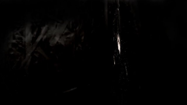 Texture of a shot into a wall, bulletproof vest from a firearm, through penetration of an obstacle by an incendiary projectile, the bullet breaks through the barrier in slow motion