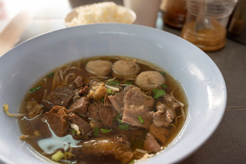 Braised beef soup And meatballs in a white bowl Closeup view from above Is a popular street food in Thailand.