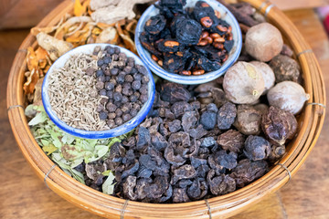 Herbs and spices on weave threshing basket ingredients used in herbal medicine.