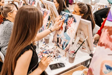 Foto op Plexiglas Young women paint with brushes on easels in art class. art school, creativity and people concept © Екатерина Рукосуева