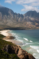 The coastline of the Cape in South Africa where beautiful mountains fall into the clear ocean on a summer day - 334370965