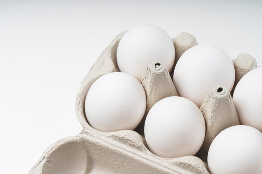 six white chicken eggs, top view, selective focus tinted image