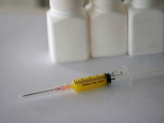 syringe has a sharp needle on white background