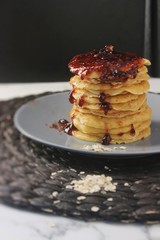 stack of pancakes with maple syrup and blueberries