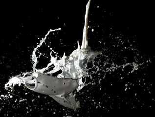 jet of milk with splashes on a black background