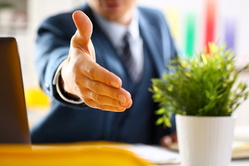 Man in suit and tie give hand as hello in office closeup. Friend welcome mediation offer positive...