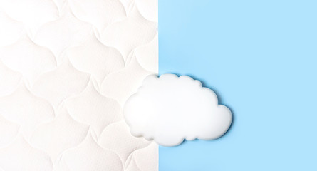 White air cloud on a comfortable mattress texture background and blue background top view. White texture of mattress bedding background. Healthy sleep concept, comfortable bed, weightlessness