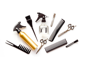 Professional hairdressing set with combs, spray and sciccors on white background top-down