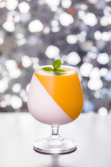 Mango Panna Cotta and Milk Pudding in the glass put on the bar.