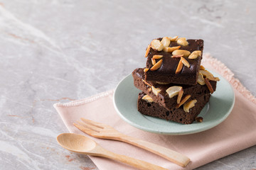 Chocolate brownie cake sprinkle with almonds and cashews.
