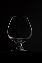 Close-up of an empty glass goblet stands on table