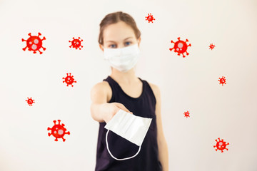 Teenage girl in a medical mask offers a medical mask to another around viruses fly