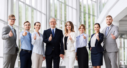 people, work and corporate concept - happy business team showing thumbs up at office
