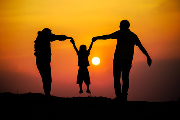 Happy family, father, mother, son in nature, sunset