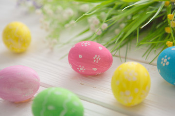 Obraz na płótnie Canvas Easter eggs on a white wooden surface