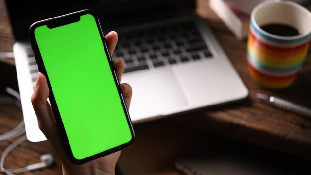 Using smartphone with a vertical green screen .