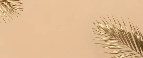 Fototapete Badezimmer Gold colored tropical palm leaves on beige background flat lay top view copy space. Creative summer background with tropical leaves. Golden background, minimal nature concept  © olgaarkhipenko