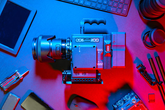 Top View of Colorful Creative Filmmakers Office Desk with Camera and Supplies
