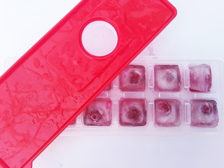 ice with cherry in a glass on a white background