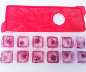 ice with cherry in molds on a white background