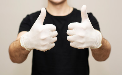 male hands in white medical gloves close up