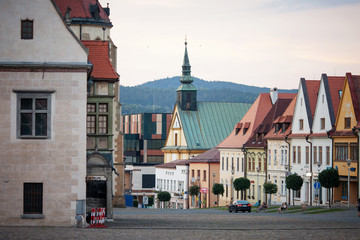 Obraz premium Historic town square in Bardejov, Slovakia with old historical town square with preserved bourgeois houses with colorful facades. Evening time UNESCO world heritage.