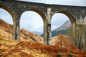 Glenfinnan train viaduct in a cloudy, rainy weather, Scotland