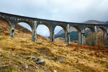 Glenfinnan train viaduct in a cloudy, rainy weather, Scotland