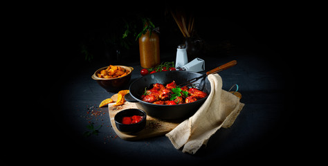 Spicy chicken wings in honey with potato wedges