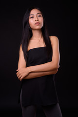 Portrait of young beautiful Asian woman with arms crossed