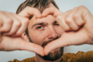 Fototapeta premium man making a hand heart frame