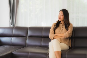 Fototapeta premium Portrait beautiful young asian woman happy smile relax on sofa in living room