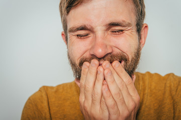 man laughs and covers her mouth