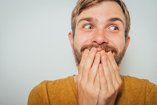 man laughs and covers her mouth