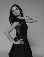 Fototapeta premium Black and white portrait of a stunning sexy young brunette girl in black drees, Beauty and Fashion