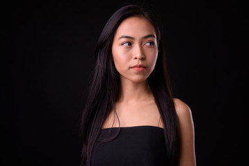 Fototapeta premium Face of young beautiful Asian woman thinking